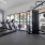 a gym with exercise equipment and large windows