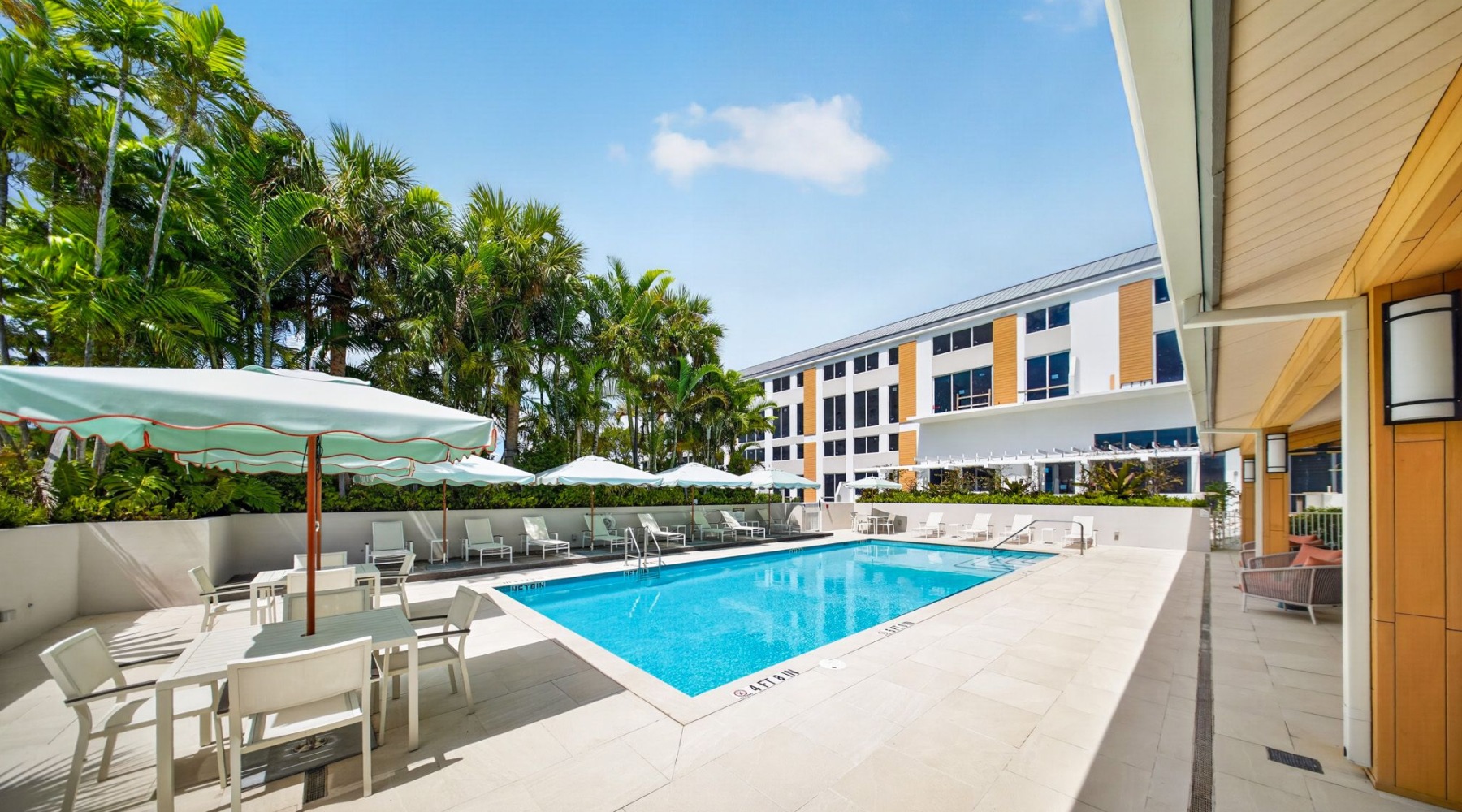 Resort-style swimming pool with lounge seating