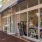 a shop with large windows off of a side walk